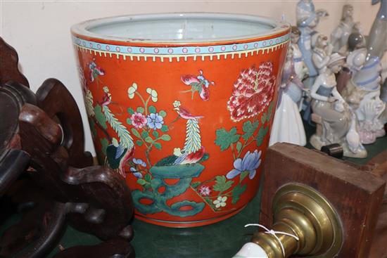 A Chinese coral ground famille rose jardiniere, wood stand Total height 60cm